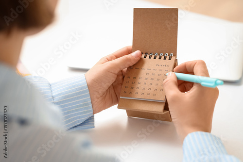 Woman marking day on flip c...