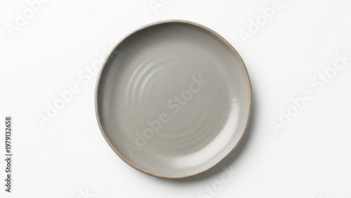 A top-down view of a gray ceramic plate with a ribbed interior and brown rim on a white background