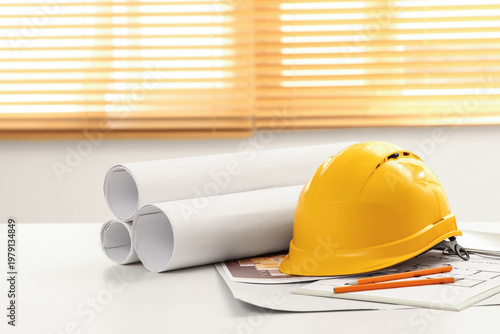 Hardhat with house plans on...