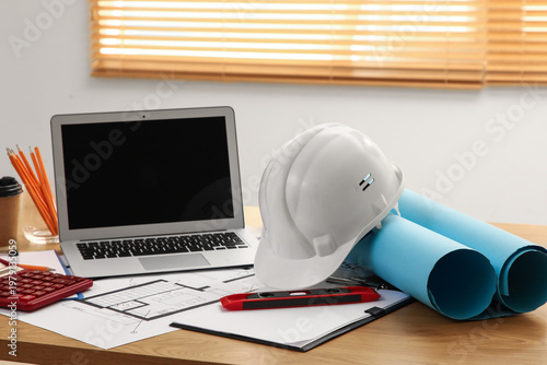 Blank laptop with hardhat a...