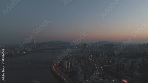 Aerial night view of the illuminated Seoul skyline and Han River from Gwangjin-gu, South Korea.