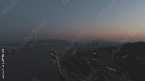 Aerial night view of the illuminated Seoul skyline and Han River from Gwangjin-gu, South Korea.