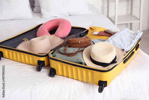 Unpacked suitcase with clot...