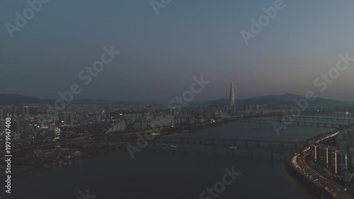 Aerial night view of the illuminated Seoul skyline and Han River from Gwangjin-gu, South Korea.