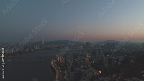 Aerial night view of the illuminated Seoul skyline and Han River from Gwangjin-gu, South Korea.