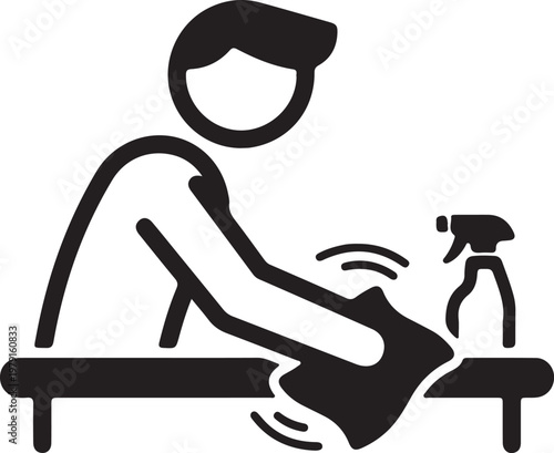 Person cleaning table surface with cloth and disinfectant spray bottle.