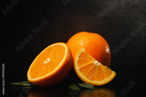 Tasty cut oranges with leav...