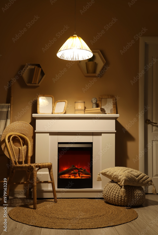 Obraz premium Interior of dark living room with fireplace, chair and glowing lamp at night