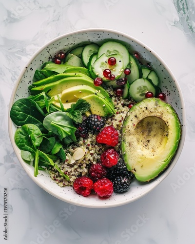 Healthy and vibrant vegan buddha bowl with fresh vegetables, berries, and quinoa.