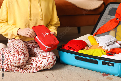 Young woman with suitcase p...