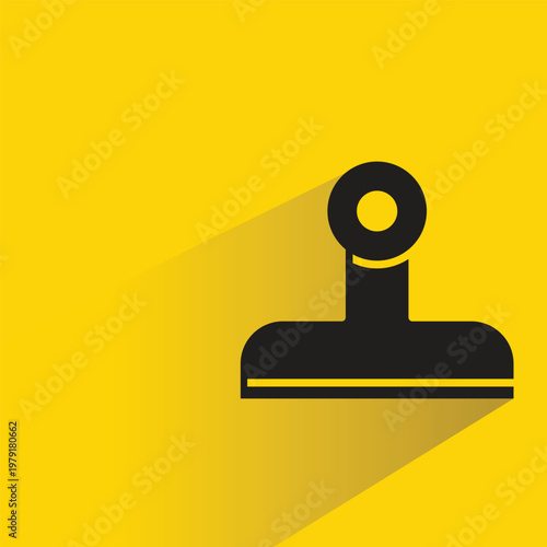 paper clip icon with shadow on yellow background
