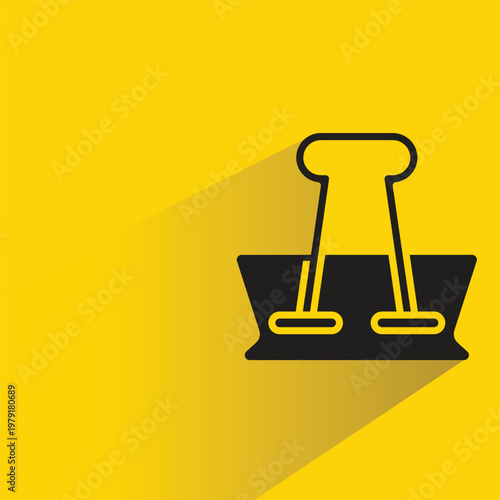 paper clip icon with shadow on yellow background