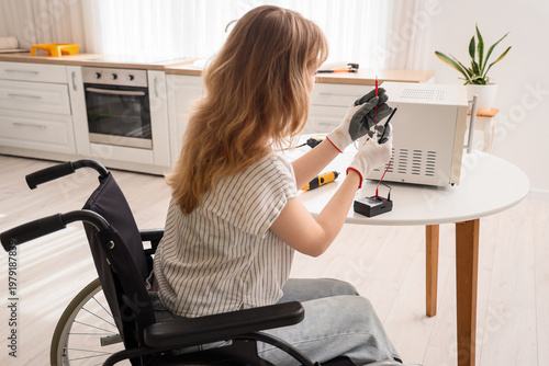 Young woman in wheelchair w...