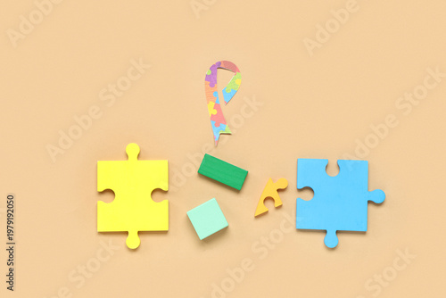 Puzzle, plasticine and awareness ribbon on beige background. Autism disorder ...