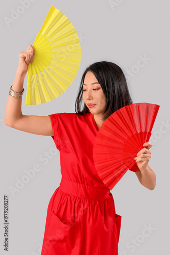 Young Asian woman with fans...