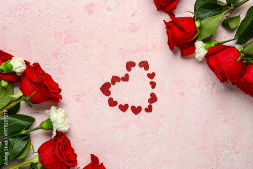 Red roses, carnations and hearts on pink grunge background