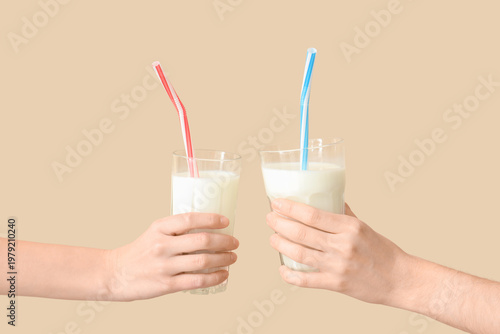 Hands holding glasses of mi...