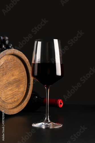 Glass of red wine with barr...