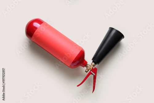 Fire extinguisher on grey b...
