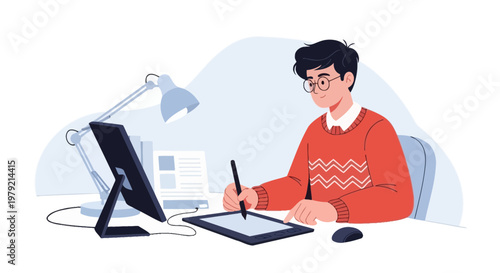 Young graphic designer working on a digital tablet with a computer and lamp on desk