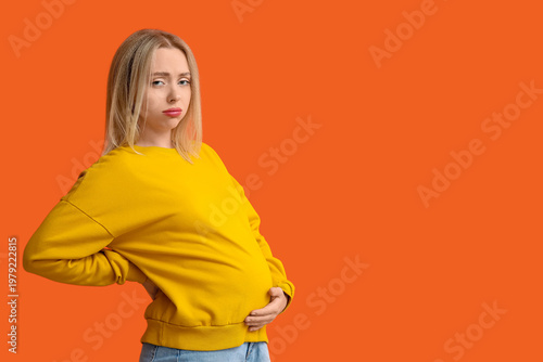 Sad pregnant woman on orang...