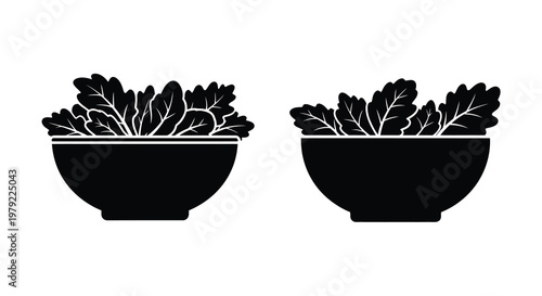Two black bowls overflowing with leafy green vegetables a simple design