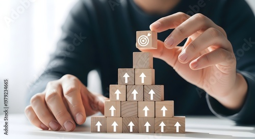 Concept of Business Growth and Strategy: Building a Goal Pyramid with Wooden Blocks for Success