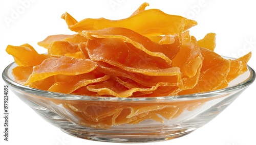 Bright orange dried mango slices piled high in a clear glass bowl