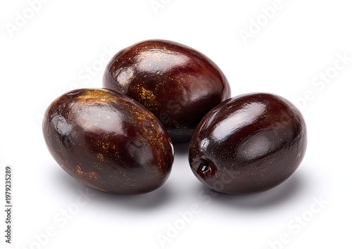 Three ripe, dark-skinned, oval fruits arranged closely on a white surface