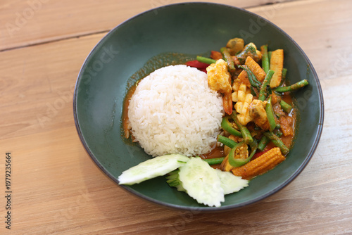 Seafood curry rice in a green plate.