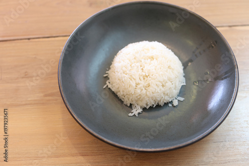 White rice in a black plate, with space left for copying.