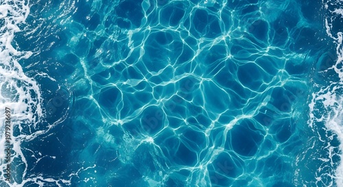 Ocean's Tranquility: A captivating aerial view unveils the mesmerizing dance of sunlight on the surface of the vast ocean, a symphony of sparkling turquoise hues that invoke serenity and wonder.