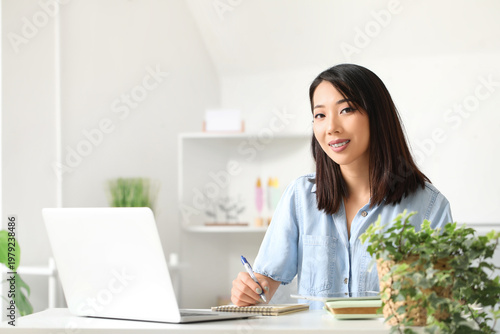 Beautiful Asian woman learn...