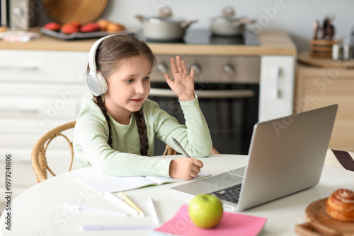 Little girl in headphones w...