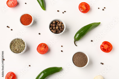 Composition with different spices and vegetables on light background