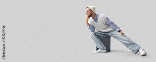 Stylish young man sitting o...