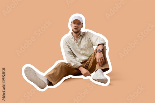 Stylish young man sitting o...