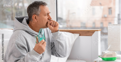 Mature man with nebulizer c...