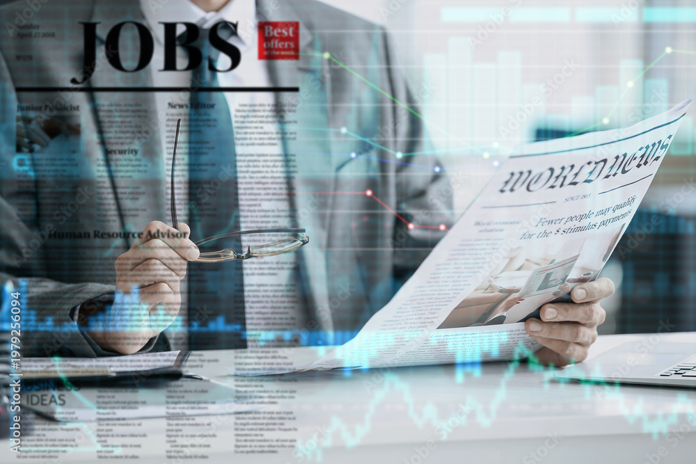© Pixel-Shot - Young businessman with eyeglasses reading newspaper in office