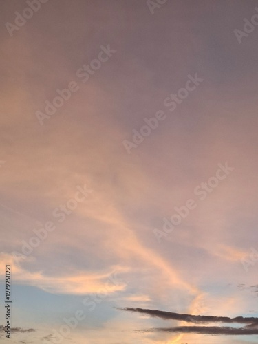 Subtle sunset light illuminating thin clouds in a peaceful dusk sky