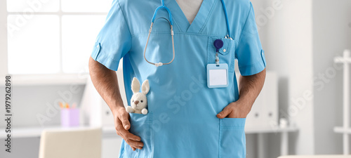 Male pediatrician with toy ...