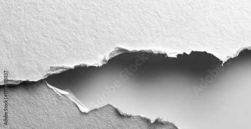 Jagged tear reveals a dark void between textured white paper layers