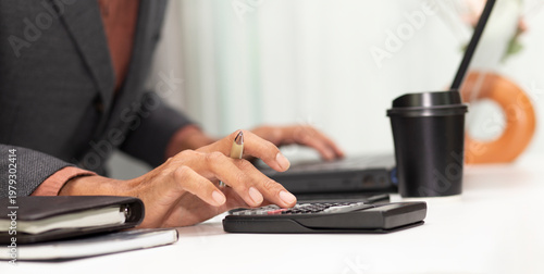 Принти на полотні businessman use calculator with calculate budget or tax at workplace