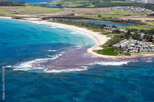 Historic view of Shellharbour South Beach prior to the construction of Shell Cove and Marina, located south of Wollongong on the Illawarra coastline. Captured from high above on a blue sky day. 