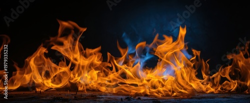 The Flames Dancing Across a Dark Background with Blue and Orange Glow