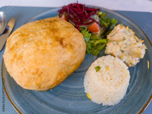 Fish fillet stuffed with shrimp and cheese, breaded, and also served with rice and vegetables
