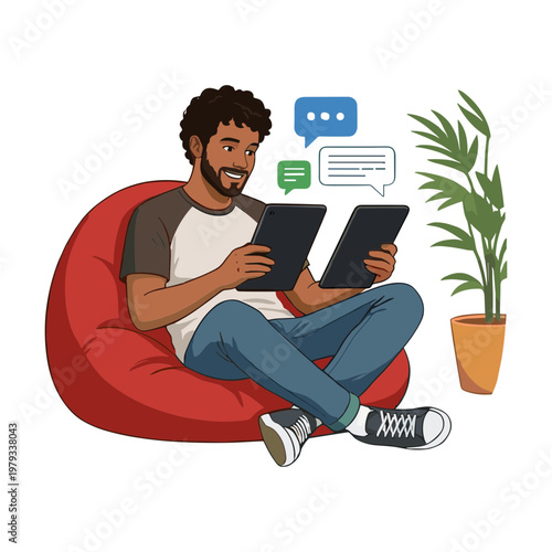A man sits on a bean bag chair with tablets chatting on a plant beside him indoors.
