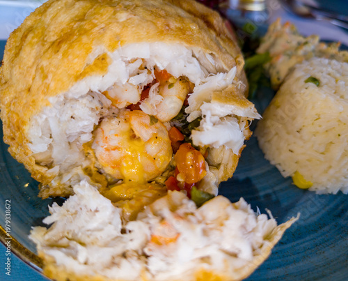 Fish fillet stuffed with shrimp and cheese, breaded, and also served with rice and vegetables