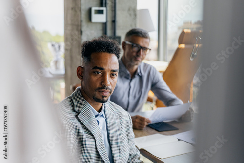 Ambitious young individual engaging with senior advisor through reflection