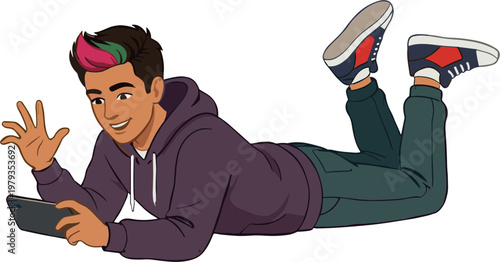 A young man lies on his stomach smiling while holding a tablet.